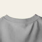 peach wall closeup t shirt mockup back neck focus on minimalist design and fabric texture 01747 1